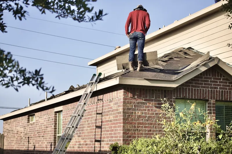 Professional roofer working on a residential roof in Rusk
